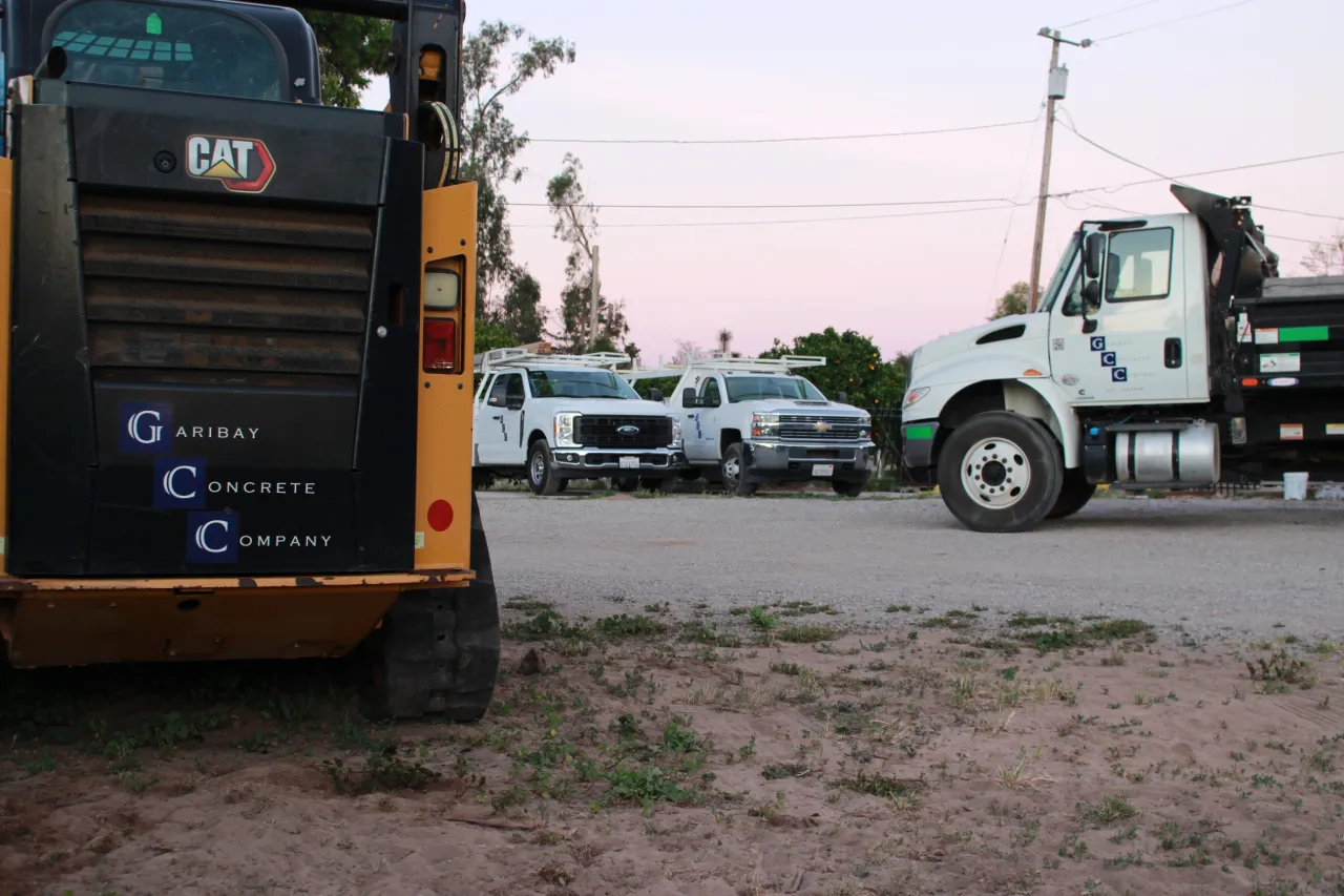 Garibay Concrete Company skid steer, crew trucks, and dump truck staged at a worksite in Santa Maria, CA